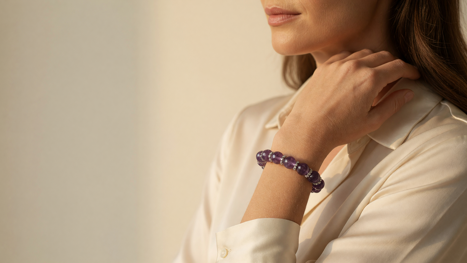 Kairo banner 2 Worn Light desktop - woman in cream silk blouse wearing an amethyst crystal bracelet
